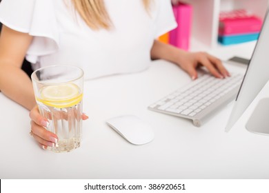 Woman Having Water With Lemon At The Office 