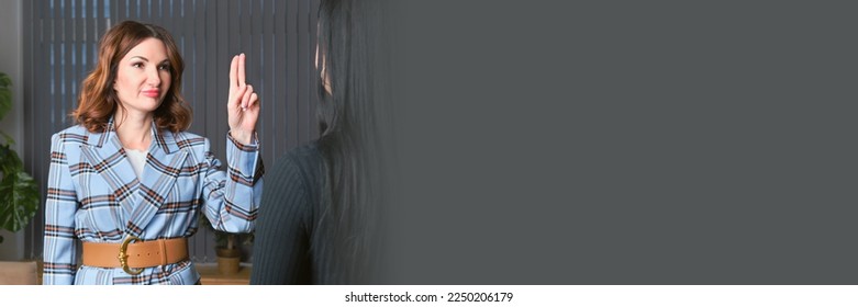 Woman is having a wingwave session with a client. Certified coach uses an integrative neuropsychological method aimed at working with destructive emotional states. Banner with free space for text - Shutterstock ID 2250206179