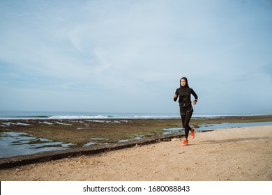 Woman With Head Scarf Running. Sport Muslim Woman Run Outdoor On Summer