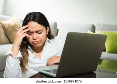 Woman with headache working on computer