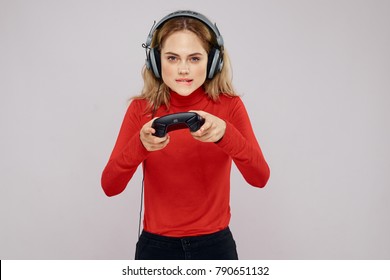 Woman In Headphones With Joystick Playing In Playstation On Gray Background                               