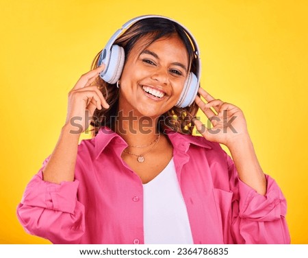Woman, headphones and listen to music in portrait, happiness and entertainment on yellow background, Fun, audio streaming and radio with rave or techno in studio, student with wireless tech and smile
