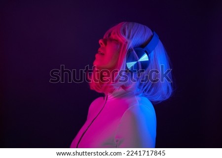 Young woman dancing and listening to music