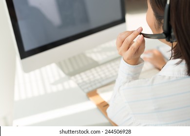 Woman With Headset Working On Computer, View Over The Shoulder