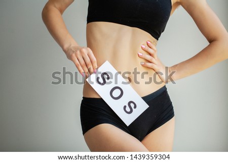 Woman Health. Female Body Holding Symbol Help Card Near Stomach.