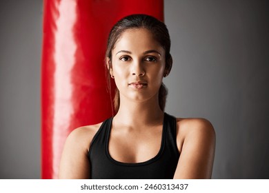 Woman, health and portrait in gym with punching bag for fitness, workout or training for wellness. Female person, exercise and confidence for sport in mma or boxing athlete, martial arts in New York - Powered by Shutterstock