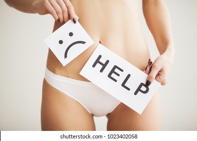 Woman Health Problem. Closeup Of Female With Fit Slim Body In Panties Holding White Card With Sad Smiley Face Near Her Stomach. Digestive Disorders, Period Pain, Health Issues Concept. High Resolution