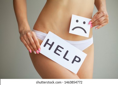 Woman Health Problem. Closeup Of Female With Fit Slim Body In Panties Holding White Card With Sad Smiley Face Near Her Stomach. Digestive Disorders, Period Pain, Health Issues Concept