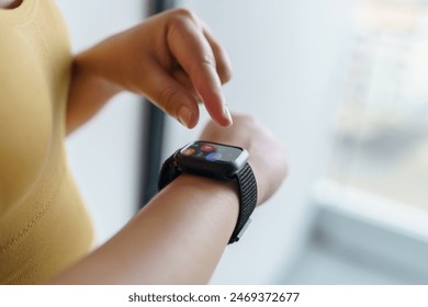 Woman workout with health app on smart watch Close-up hands.