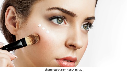 Woman With Healthy Skin Applying Cream Highlighter Under Eye