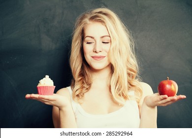 Woman with Healthy and Unhealthy Food. Difficult choice. Overweight Concept - Shutterstock ID 285292964