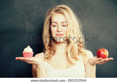 Woman with Healthy and Unhealthy Food. Difficult choice. Overweight Concept