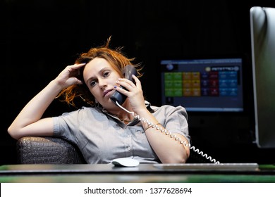 Woman Hears Negative News On The Phone. A Woman-reception Worker Accepts An Order For Booking A Room By Phone. Profile Shot Of Attractive Executives At The Reception Of Hotel. The Concept Of Service.