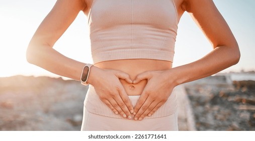 Woman, heart and hands on stomach for fitness, weightloss diet or holistic gut wellness. Closeup female abdomen, love fingers or belly emoji of body digestion, skincare and healthy exercise in nature - Shutterstock ID 2261771641