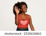 Woman in heart shape tank top. African American woman with beautiful natural hair. Black woman wearing a vest. Cute black woman waving her hand and smiling.