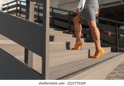 Woman In Heels Going Up Stairs Outdoors