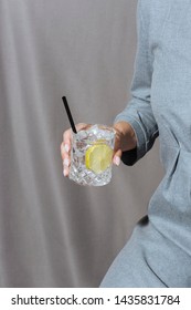 Woman Helding Gin Tonic, Grey And Moody Background