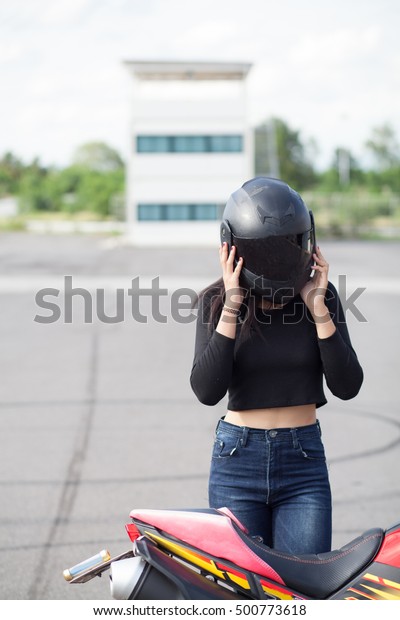 woman and helmet with\
motorcycle.