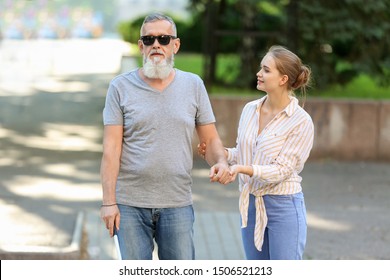 Woman Helping Blind Mature Man To Cross Road