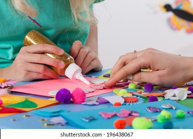 Woman helping girl in making beautiful cards - Powered by Shutterstock