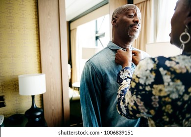 Woman Helping Her Partner In Dressing Up