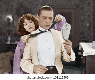 Woman Helping Man Tie Bow Tie