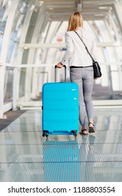 Woman with her baggage on airport terminal. Business trip - Shutterstock ID 1188803554