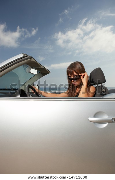 Woman and her cabriolet\
car at beach