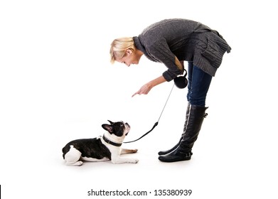 Woman with her dog on leash over white background