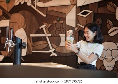 A Woman With Her Favorite Beverage In Starbucks Icon Siam Thailand.