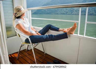 Woman With Her Feet Up On Railing Of Boat Cruise, Yangtze River China