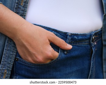 A woman with her hand in a jeans pocket. Close-up shot - Shutterstock ID 2259500473