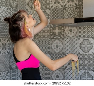 woman with her head tilted back tasting the pasta, standing over a patterned background