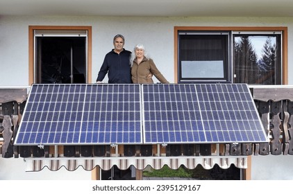 A woman and her husband are happy about the new balcony power plant - Powered by Shutterstock