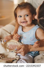 Woman With Her Little Daughter Sitting On The Floor Embroidering With A Cross-stitch Thread. Parent, Child. Crafts For Kids. Knitting Tools, Needles And Yarn