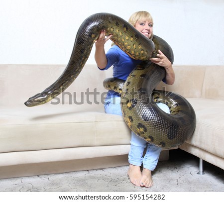 woman in her living room with a giant anaconda