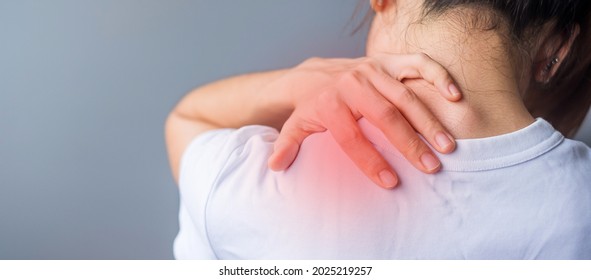 woman with her shoulder sprain, muscle painful during overwork. Girl having body problem after wake up. Shoulder ache, Scapular pain, office syndrome and ergonomic concept - Shutterstock ID 2025219257