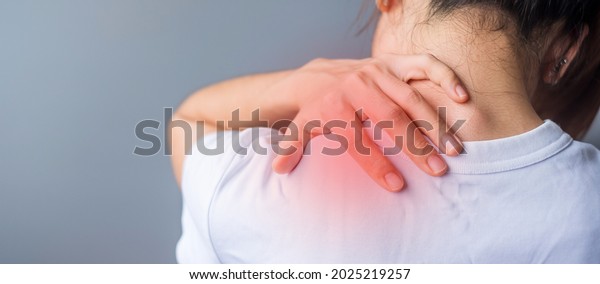 woman with her\
shoulder sprain, muscle painful during overwork. Girl having body\
problem after wake up. Shoulder ache, Scapular pain, office\
syndrome and ergonomic\
concept