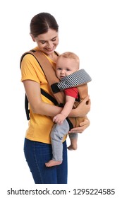 Woman With Her Son In Baby Carrier On White Background