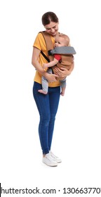 Woman With Her Son In Baby Carrier On White Background