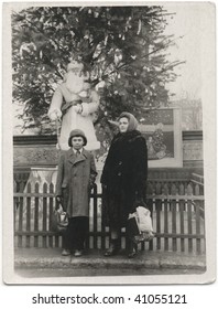 A woman with her son in the Christmas holiday. USSR, mid 20 century