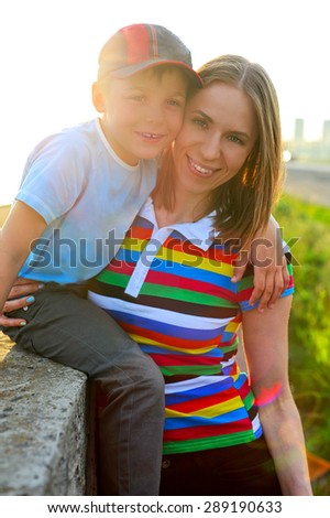woman with her son on sunrise