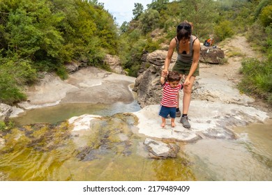 A Woman With Her Son In A River In Summer Cooling Off In The Pyrenees