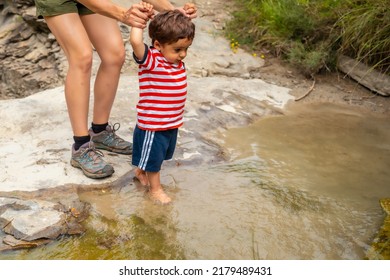 A Woman With Her Son In A River In Summer Cooling Off In The Pyrenees