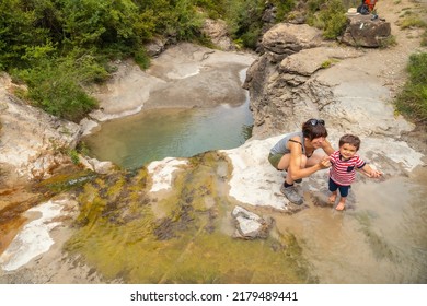 A Woman With Her Son In A River In Summer Cooling Off In The Pyrenees