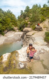 A Woman With Her Son In A River In Summer Cooling Off In The Pyrenees, Panticosa