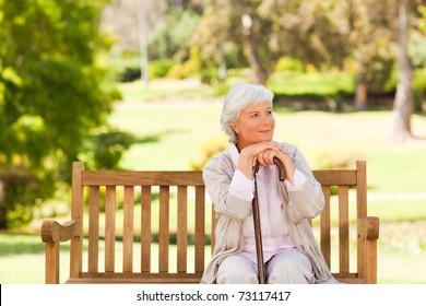 Woman With Her Walking Stick In The Park