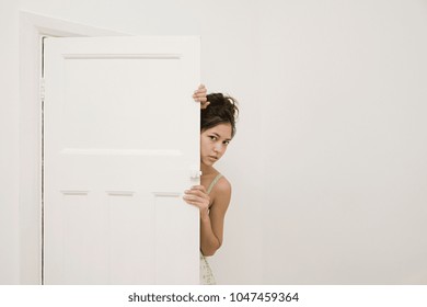 Woman Hiding Behind A Door