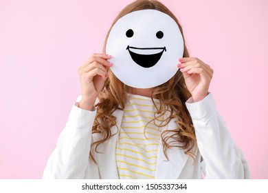 Woman Hiding Face Behind  Emoticon On Color Background