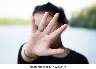 Woman Hiding Face Behind Hand. Defense Reaction.